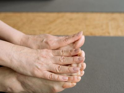 Close-up of feet on a yoga mat, showing balance.